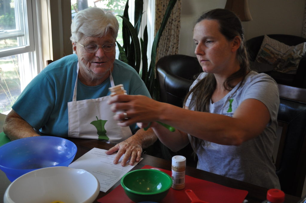 Courtney Kennedy helps an older woman with a Cooking Matters recipe in Waterboro, Maine.