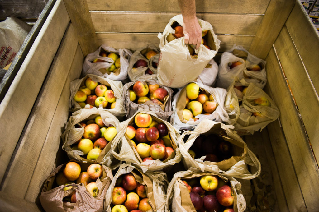 Bags of apples at a pantry partner.