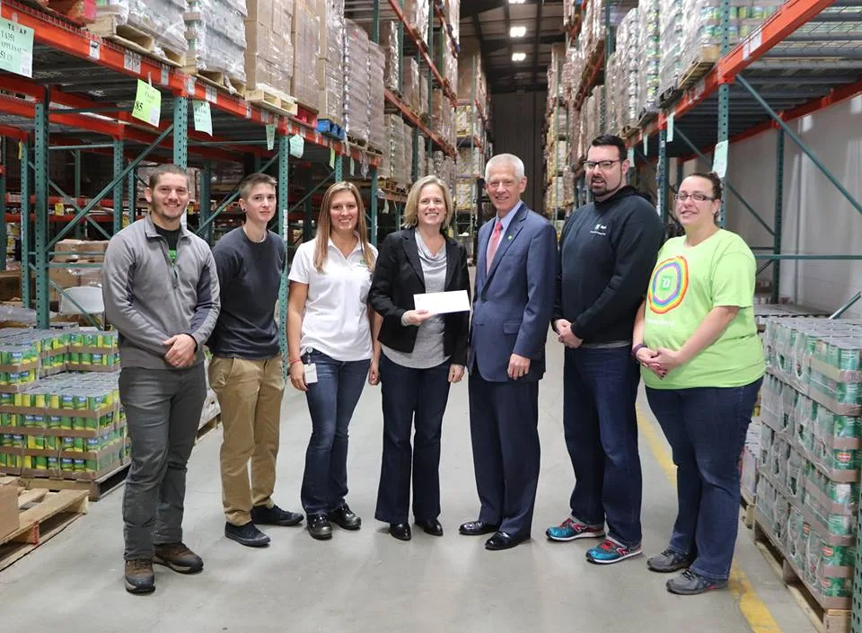 Staff of TD Bank present Kristen Miale with funds matching Giving Tuesday donations.