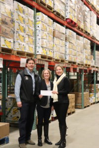 Alan and Robin LaPointe present a donation check from Strainrite and Geary Brewing for $10,000 to Kristen Miale (center).