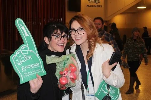 Hockey attendees show a bag full of tomato balls for Toss a Tomato.
