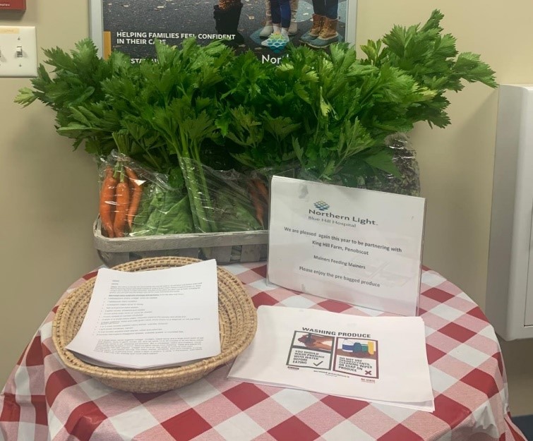 Table with produce and flyers at healthcare facility