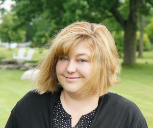 Shannon Coffin smiling outside in front of a field.