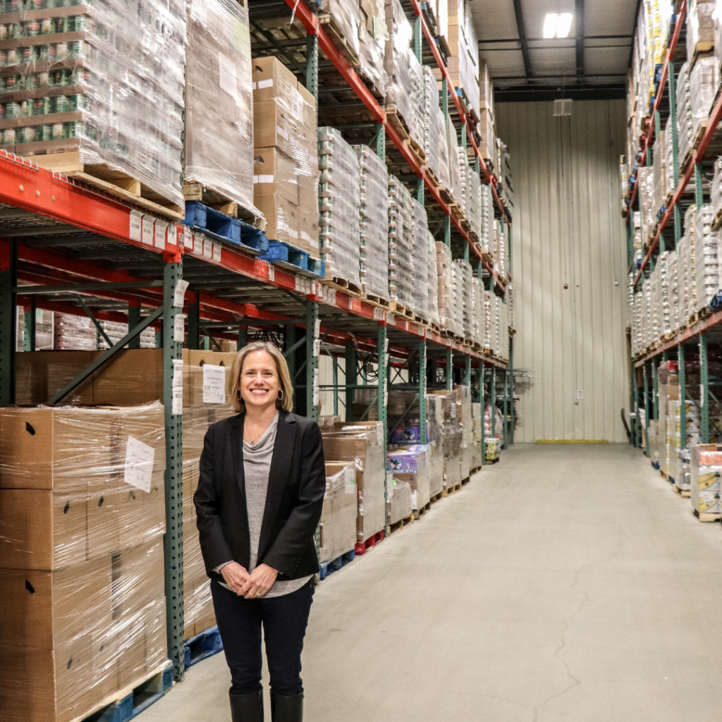 Kristen Miale, president of Good Shepherd Food Bank of Maine, standing in the Auburn Distribution Center