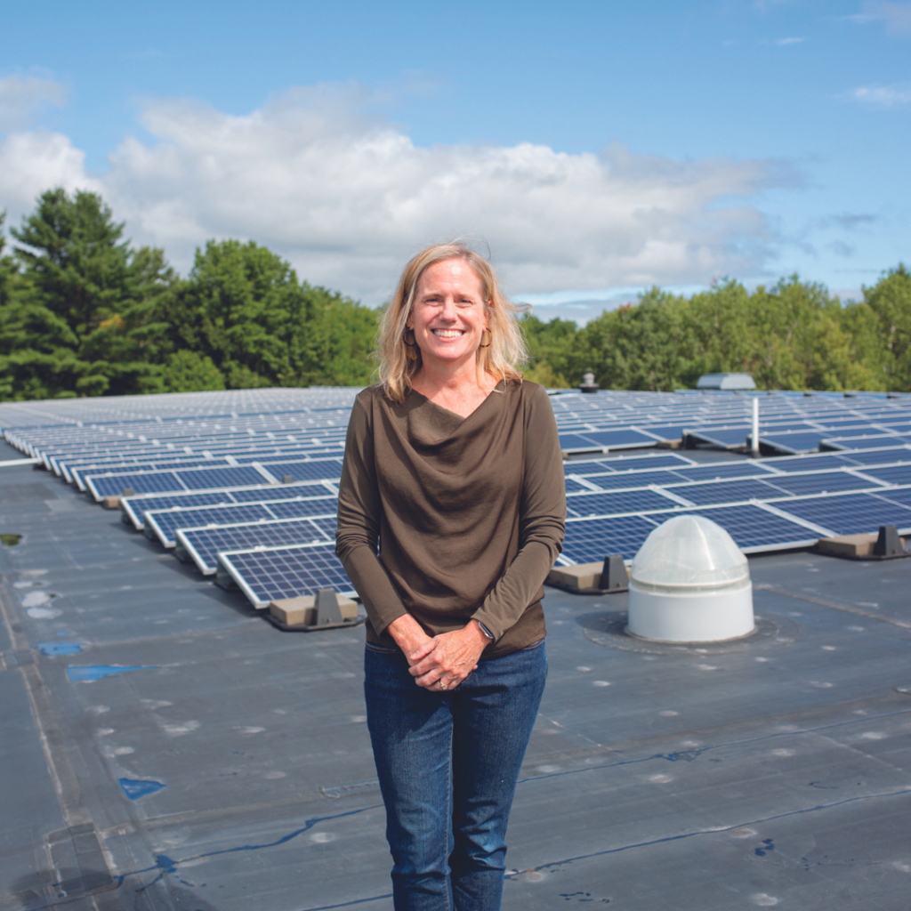 Kristen Miale standing in front of Auburn's solar panels