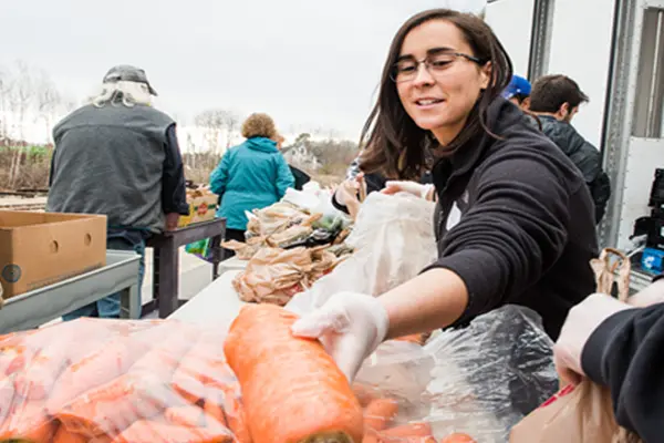 Volunteers move produce at a GSFB food mobile site.