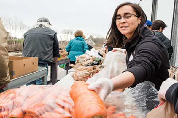 Volunteers move produce at a GSFB food mobile site.