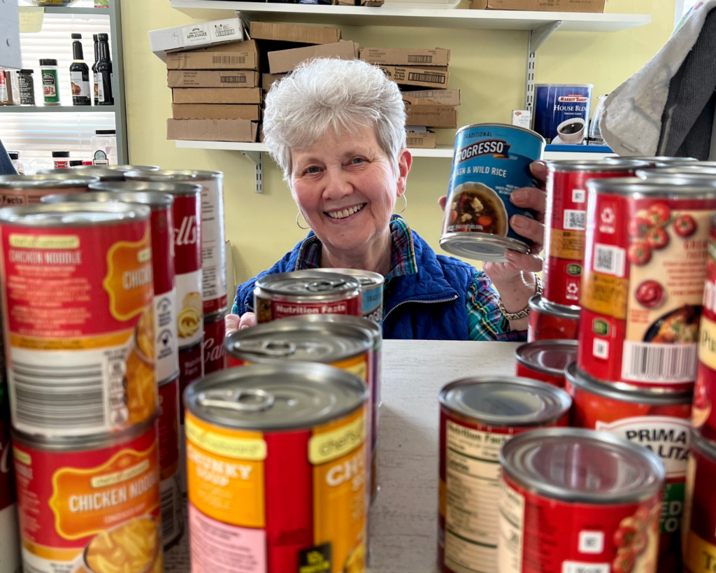 Woman with cans of food