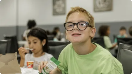 Elementary school friends enjoy lunch together at a partner of Good Shepherd Food Bank.