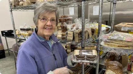 Joan helps stock the shelves at Machias Food Pantry.